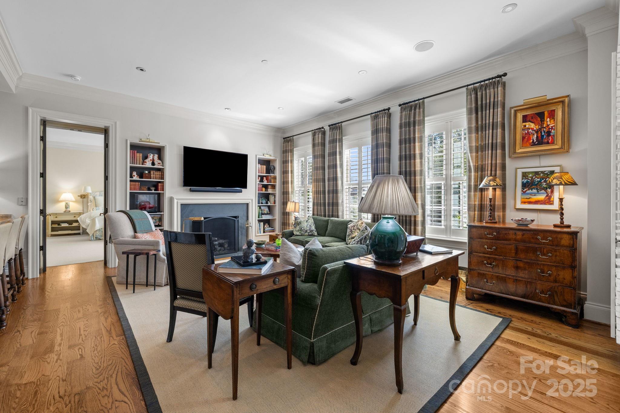 168 Cherokee Road Charlotte, NC 28207 - Photo 22 of 44 a living room with furniture a fireplace and a flat screen tv