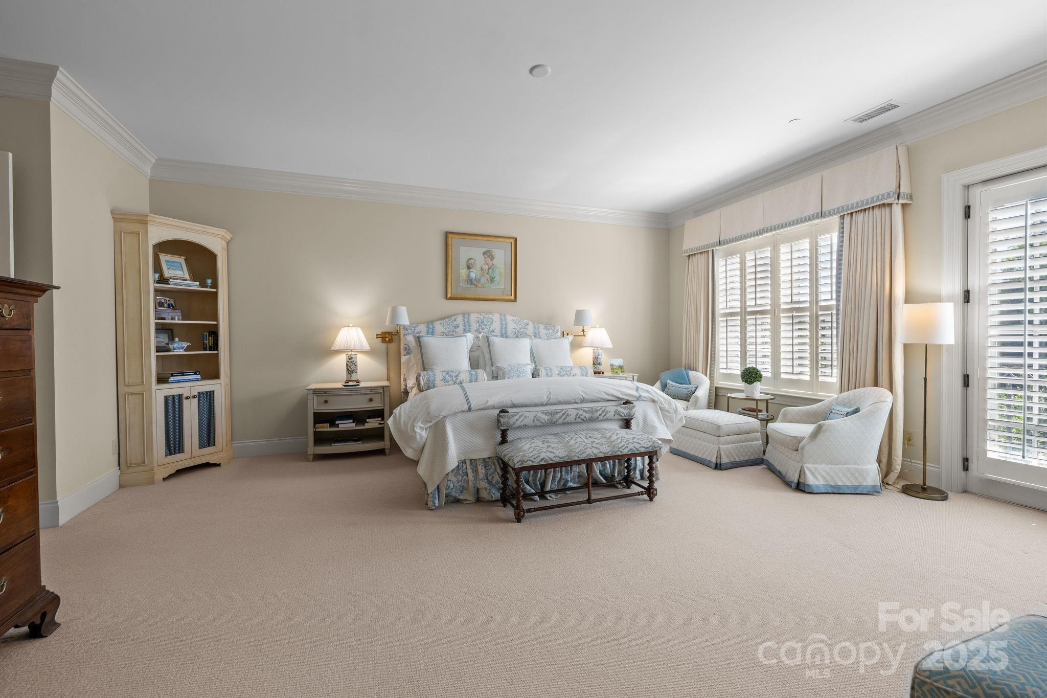 168 Cherokee Road Charlotte, NC 28207 - Photo 23 of 44 a spacious bedroom with a bed and a couch
