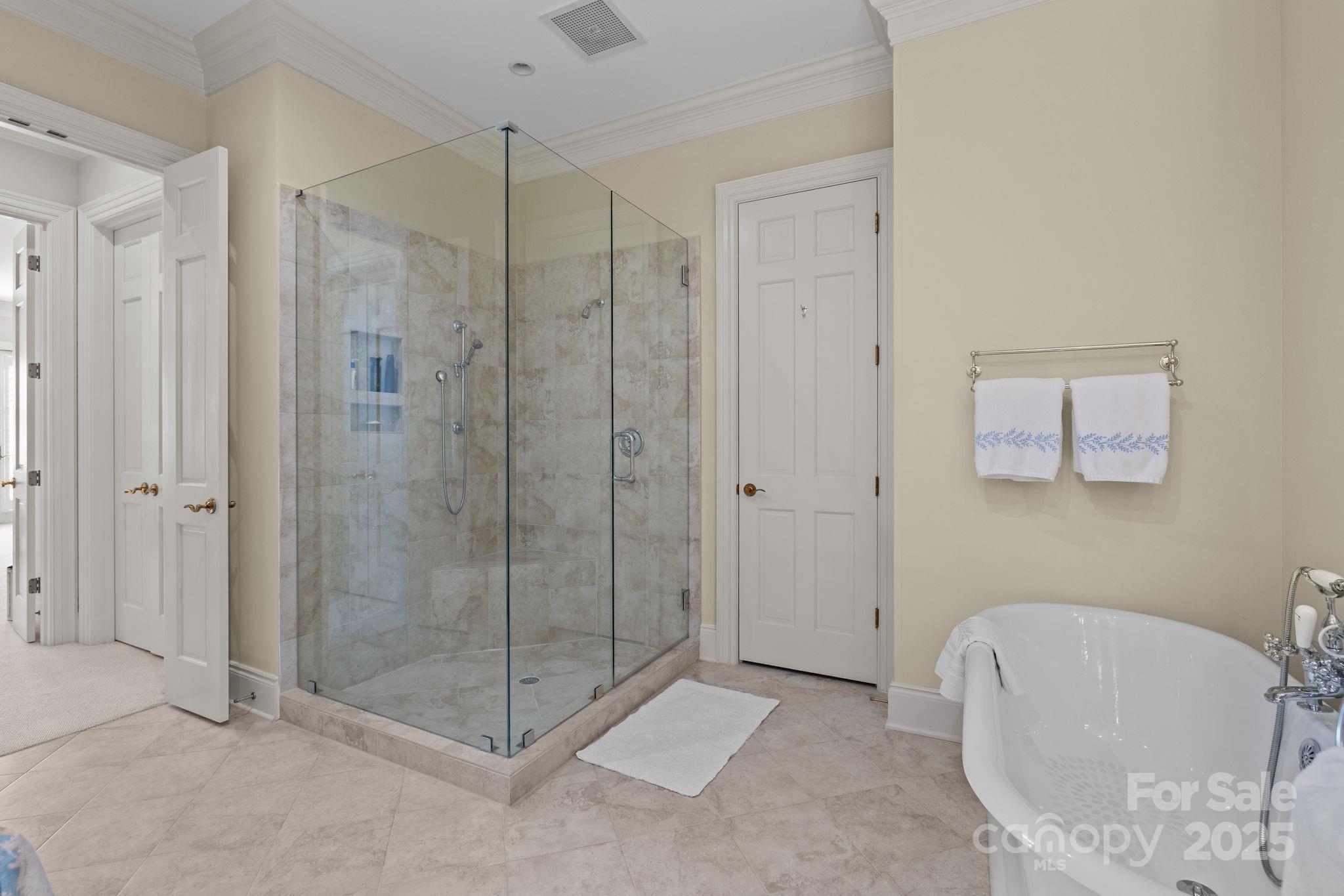 168 Cherokee Road Charlotte, NC 28207 - Photo 27 of 44 a spacious bathroom with a glass shower door