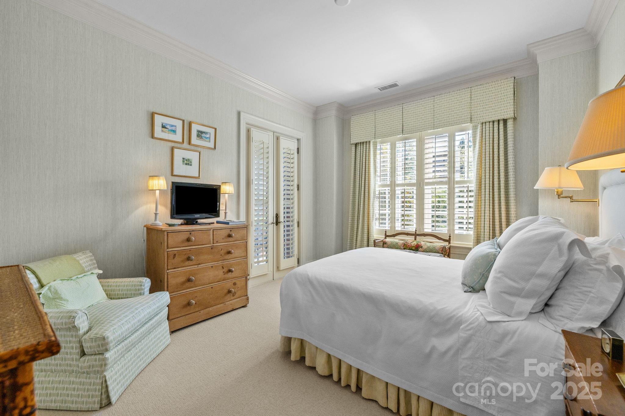 168 Cherokee Road Charlotte, NC 28207 - Photo 29 of 44 a bedroom with a bed and a television