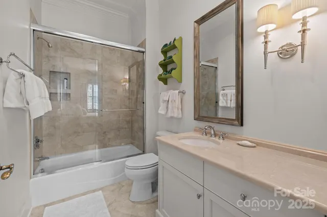 a bathroom with a bathtub shower sink and toilet
