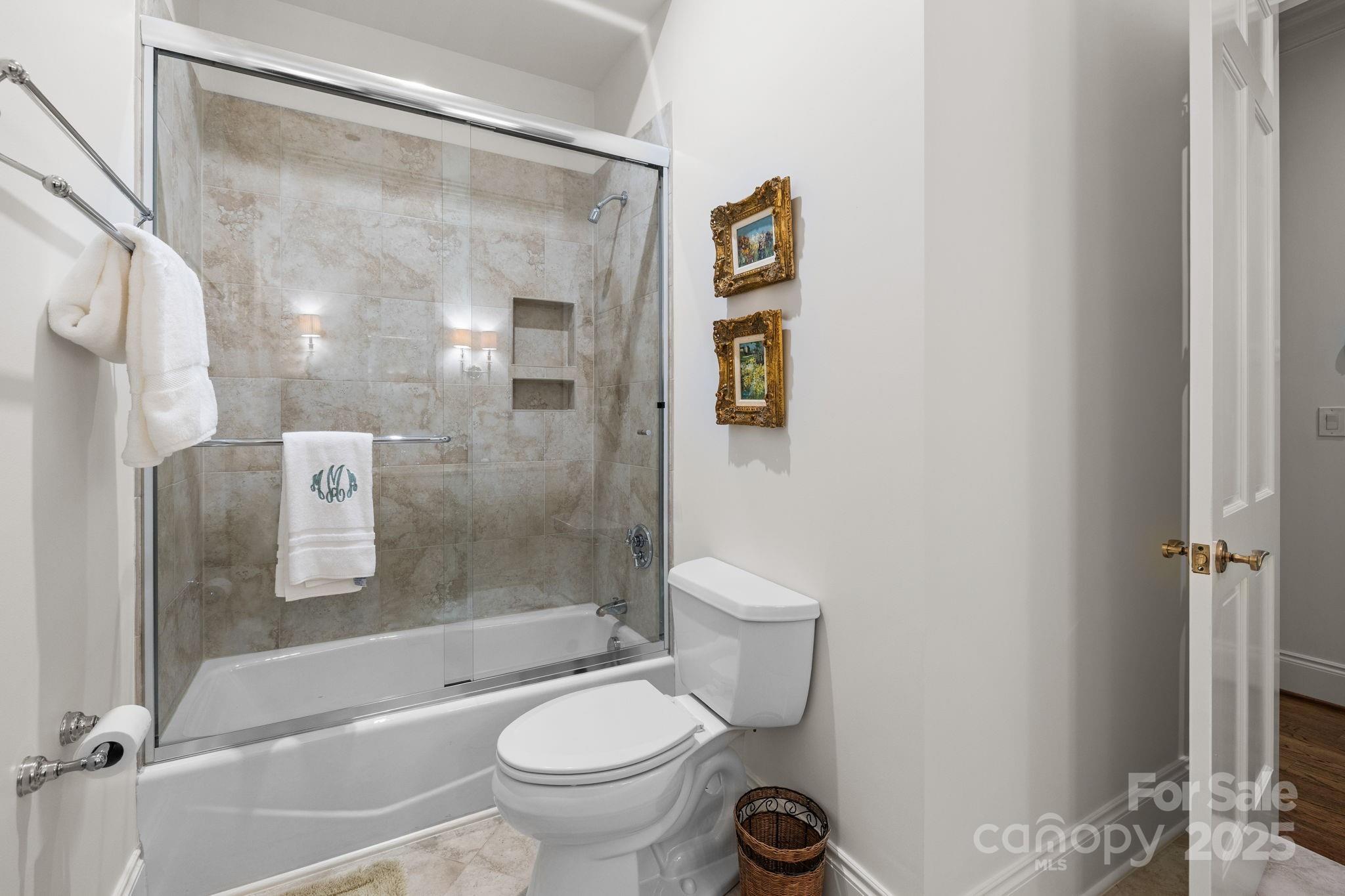 168 Cherokee Road Charlotte, NC 28207 - Photo 35 of 44 a bathroom with a shower a toilet and a sink