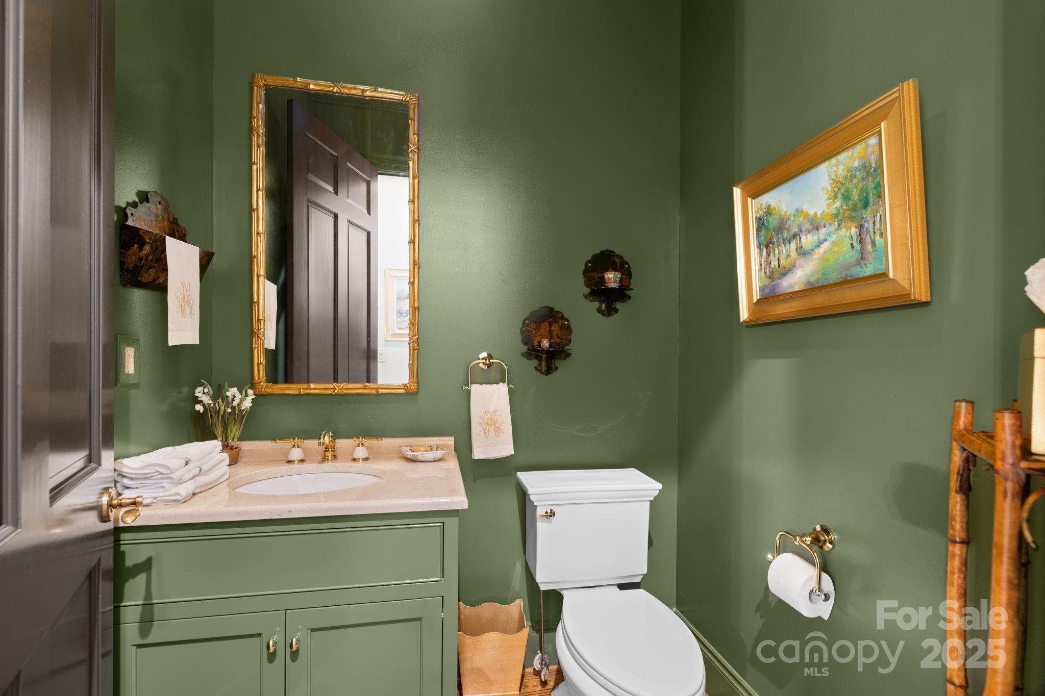 168 Cherokee Road Charlotte, NC 28207 - Photo 37 of 44 a bathroom with a toilet sink and mirror