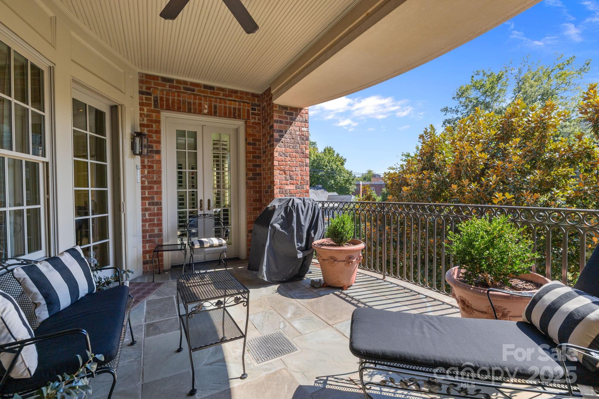 168 Cherokee Road Charlotte, NC 28207 - Photo 39 of 44 a view of a patio with couches chairs and potted plants