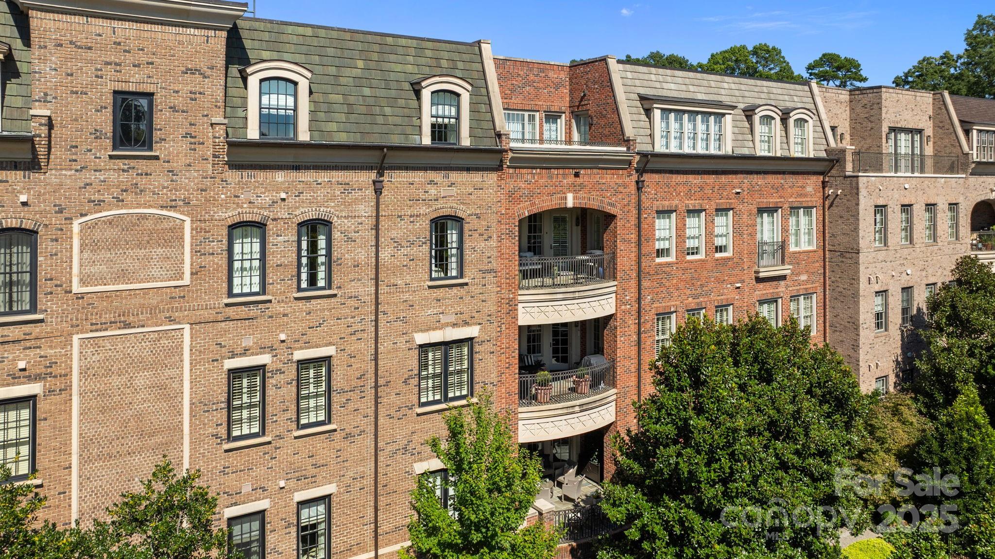 168 Cherokee Road Charlotte, NC 28207 - Photo 41 of 44 a front view of a residential apartment building with a yard