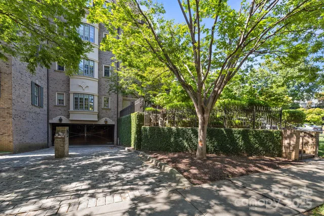 a front view of a house with a tree
