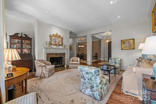 a living room with furniture a fireplace and a large window