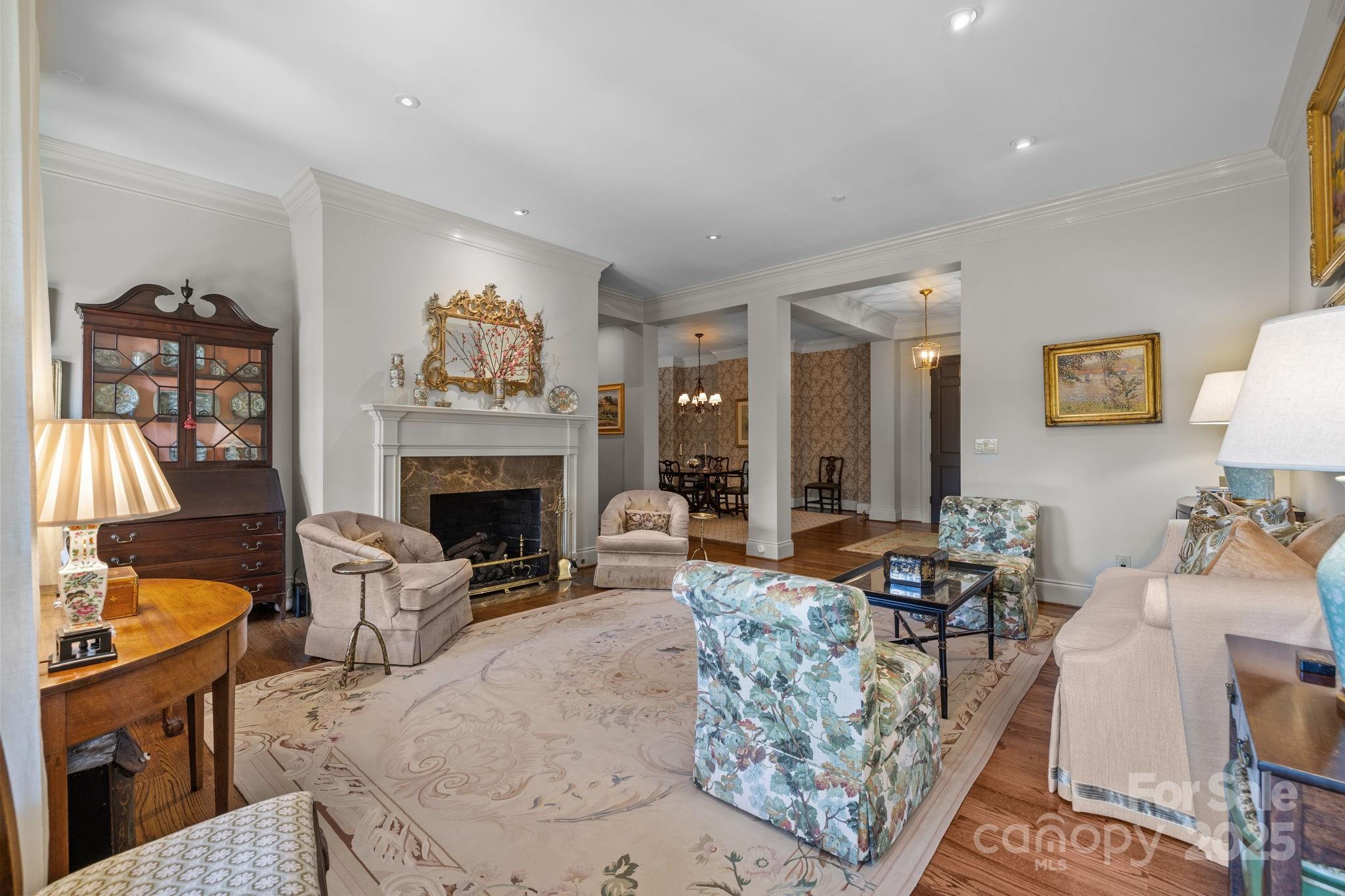 168 Cherokee Road Charlotte, NC 28207 - Photo 10 of 44 a living room with furniture a fireplace and a large window