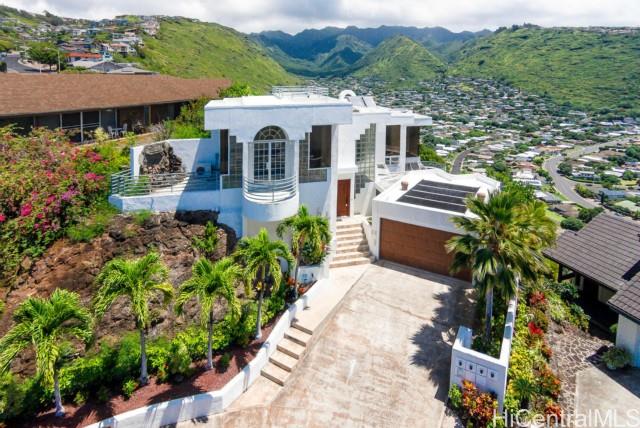 an aerial view of a house with a yard