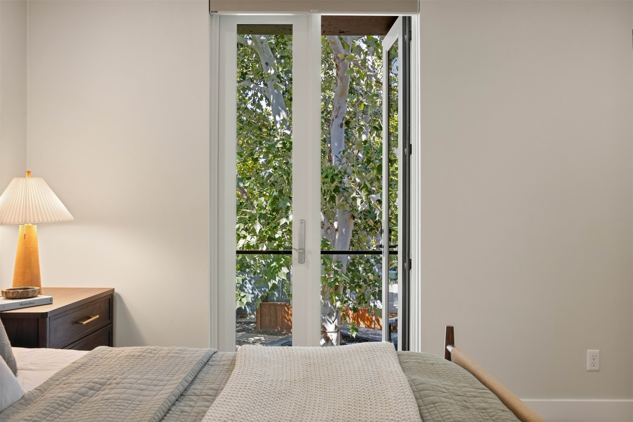 3921 Threadgill Street Austin, TX 78723 - Photo 24 of 36 Step out through the primary suite doors onto the private Juliet balcony to enjoy a fresh breeze and views over the neighborhood