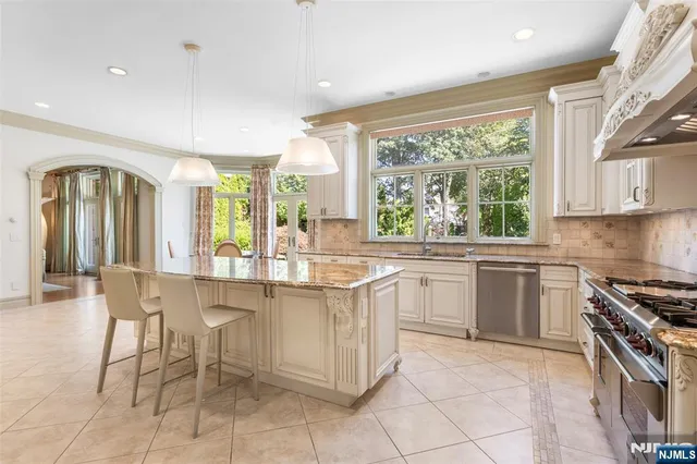 a kitchen with a sink and chairs