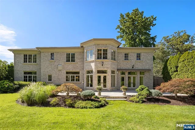 a front view of a house with a garden and plants