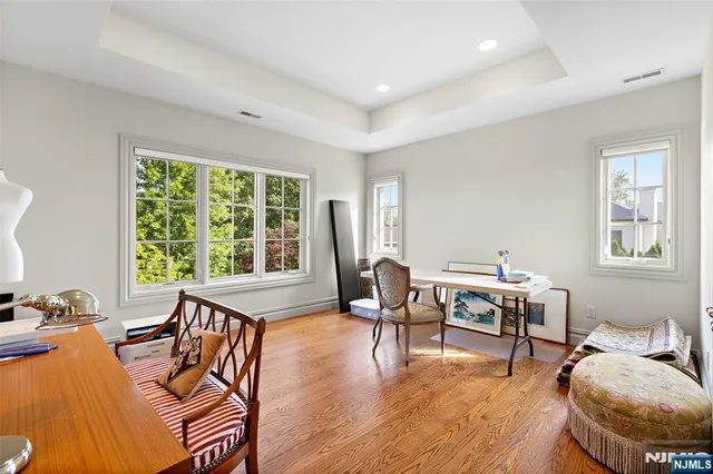 a living room with furniture and floor to ceiling windows