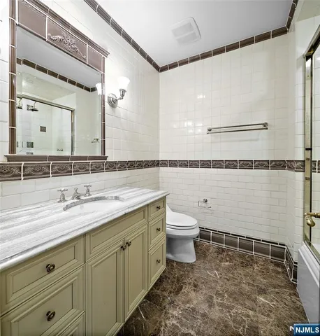 a bathroom with a sink a toilet and mirror