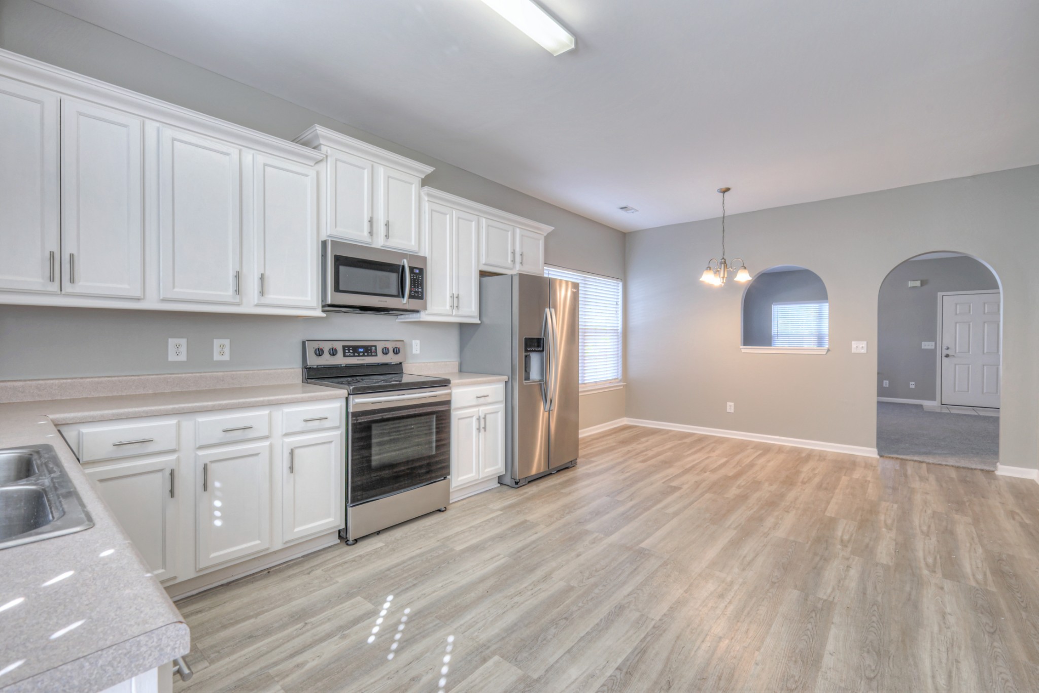1101 Downs Boulevard, Unit 147 Franklin, TN 37064 - Photo 15 of 26 a kitchen with granite countertop a refrigerator stove top oven and sink