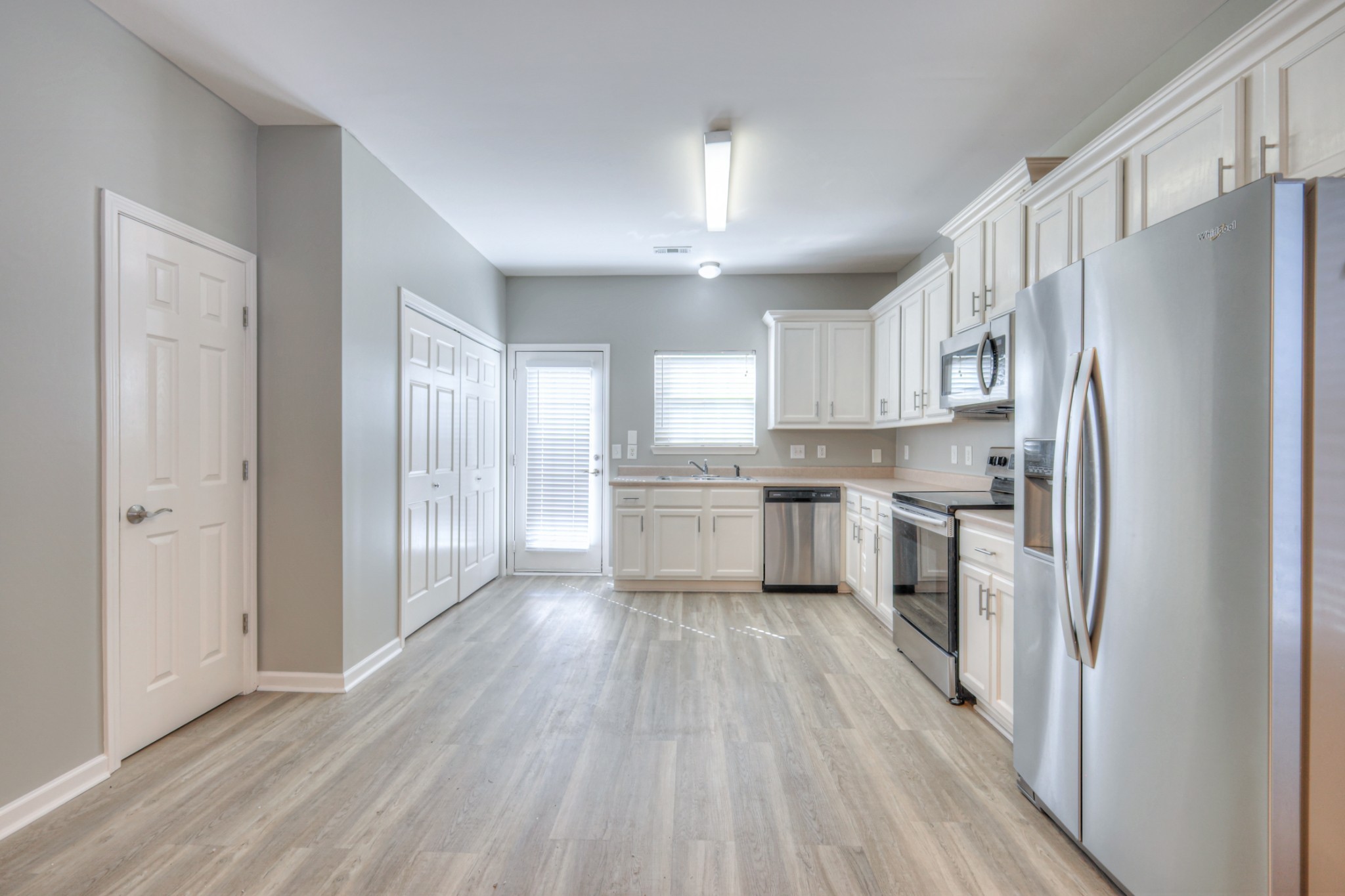1101 Downs Boulevard, Unit 147 Franklin, TN 37064 - Photo 17 of 26 a kitchen with a refrigerator a sink and cabinets