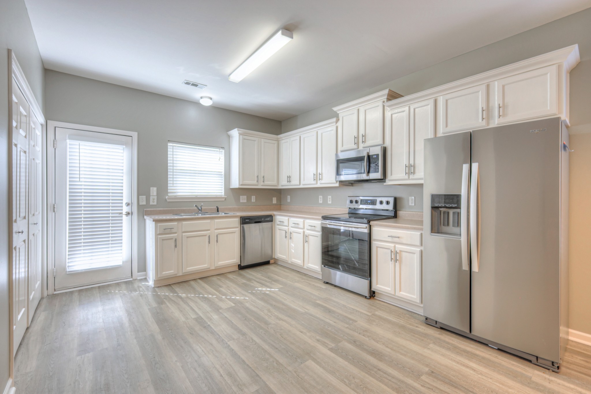 1101 Downs Boulevard, Unit 147 Franklin, TN 37064 - Photo 10 of 26 a kitchen with white cabinets and white appliances