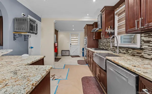 a spacious bathroom with a granite countertop sink a mirror and shower