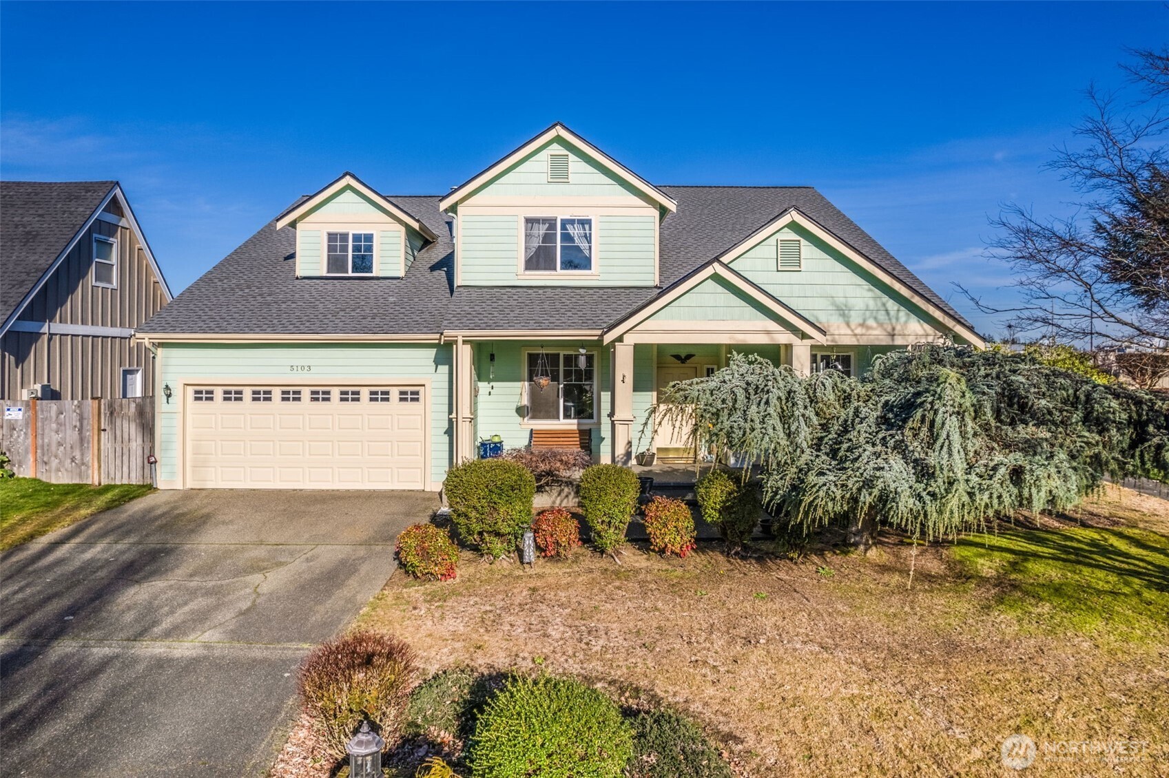 a view of a house with a yard and potted plants