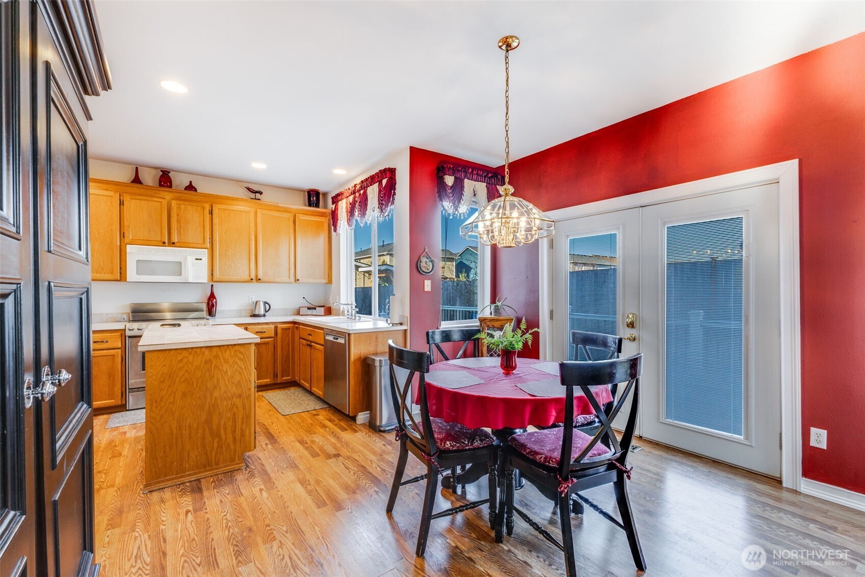 5103 80th Street Southwest Lakewood, WA 98499 - Photo 12 of 33 a dining room with a table chairs and a kitchen view