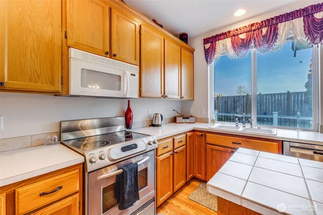 a kitchen with a stove a sink and a microwave