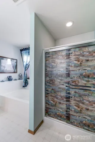 a bathroom with a shower and a sink