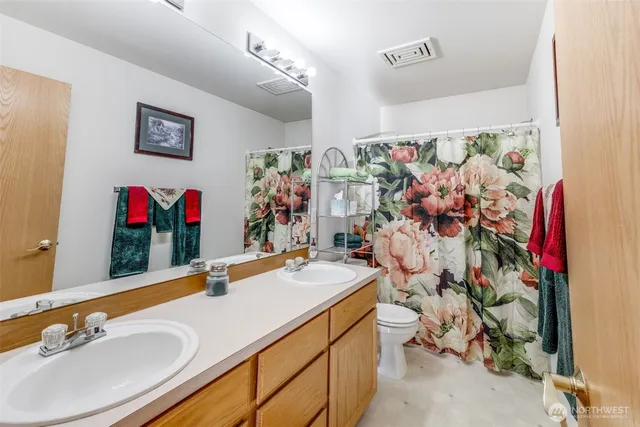 a bathroom with a sink mirror and vanity