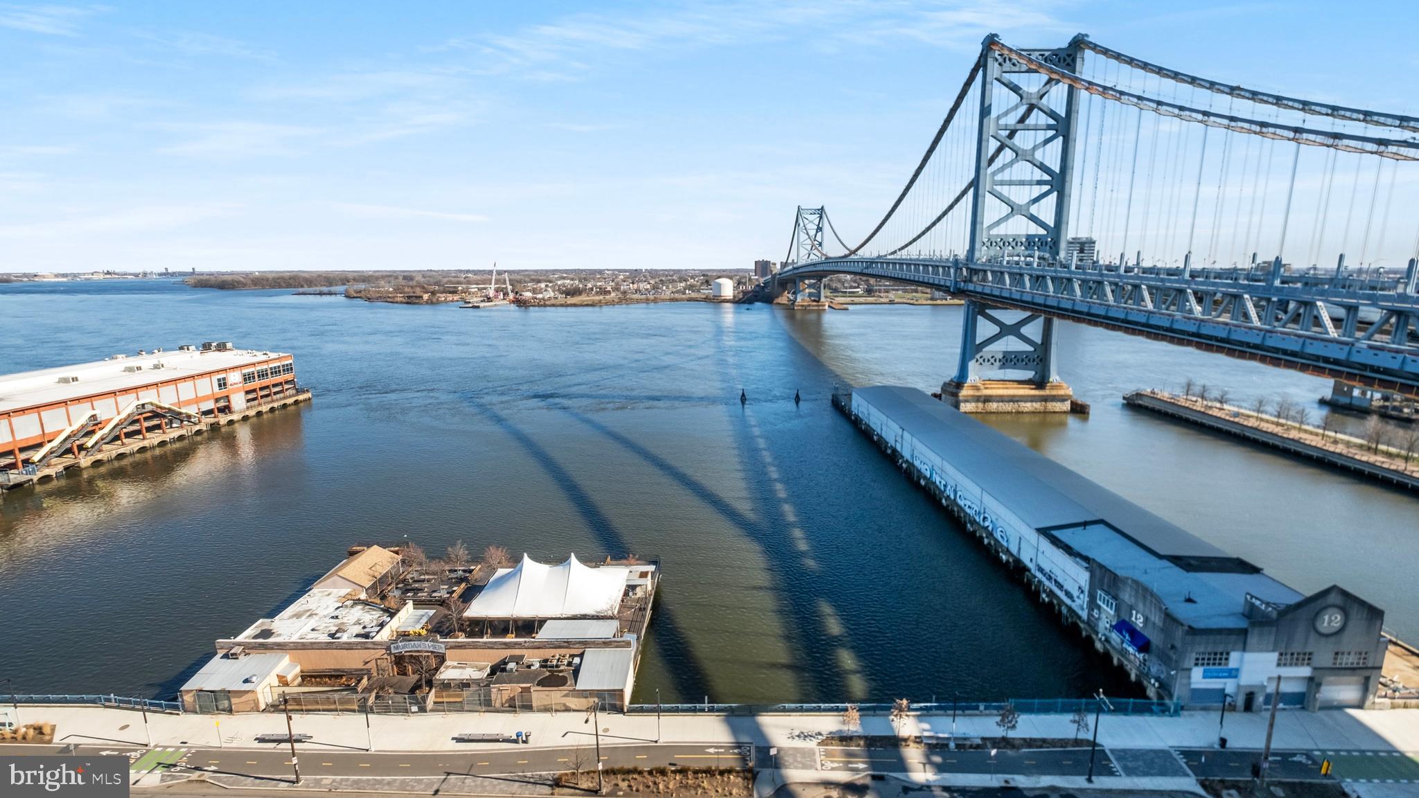 235 North Christopher Columbus Boulevard, Unit 1606 Philadelphia, PA 19106 - Photo 36 of 45 a roof deck with table and chairs next to an ocean