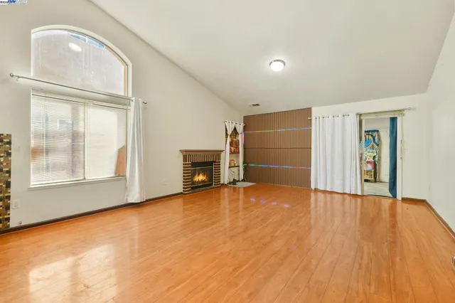 a large kitchen with kitchen island granite countertop a large window and a sink
