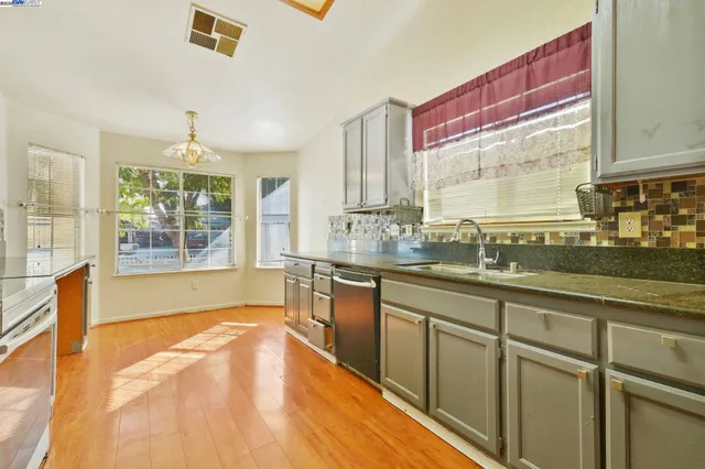 a kitchen with stainless steel appliances granite countertop a sink and cabinets