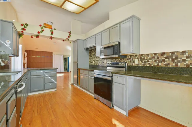 a kitchen with granite countertop a stove and a sink