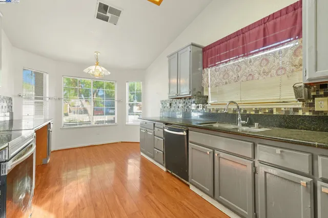 a large kitchen with kitchen island a sink stainless steel appliances and cabinets