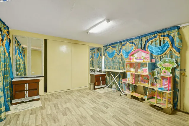a view of an empty room with a fireplace and a window