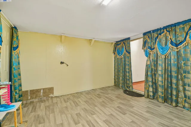 a view of an outdoor space with wooden floor and windows