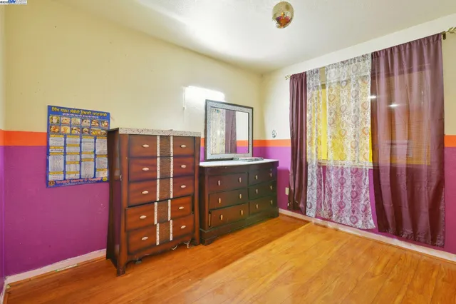 a bedroom with a bed and a dresser