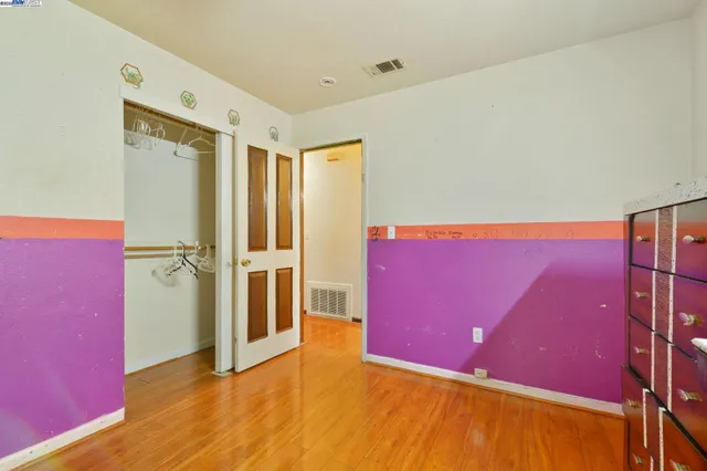 a bedroom with a dresser and a dresser