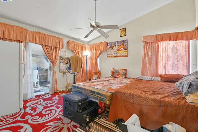 a bedroom with bed and a chandelier