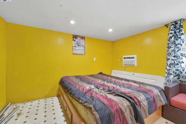 a bedroom with a bed dresser and a window