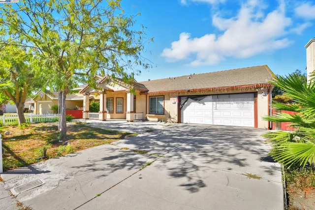 a front view of a house with a tree