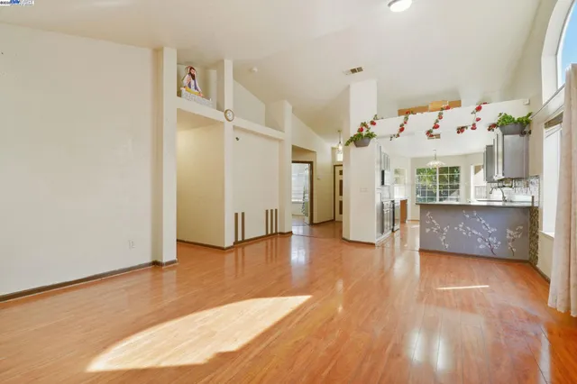 a view of a living room with hardwood floor and a large window