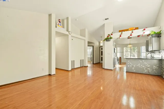 a view of open kitchen with furniture and a fireplace