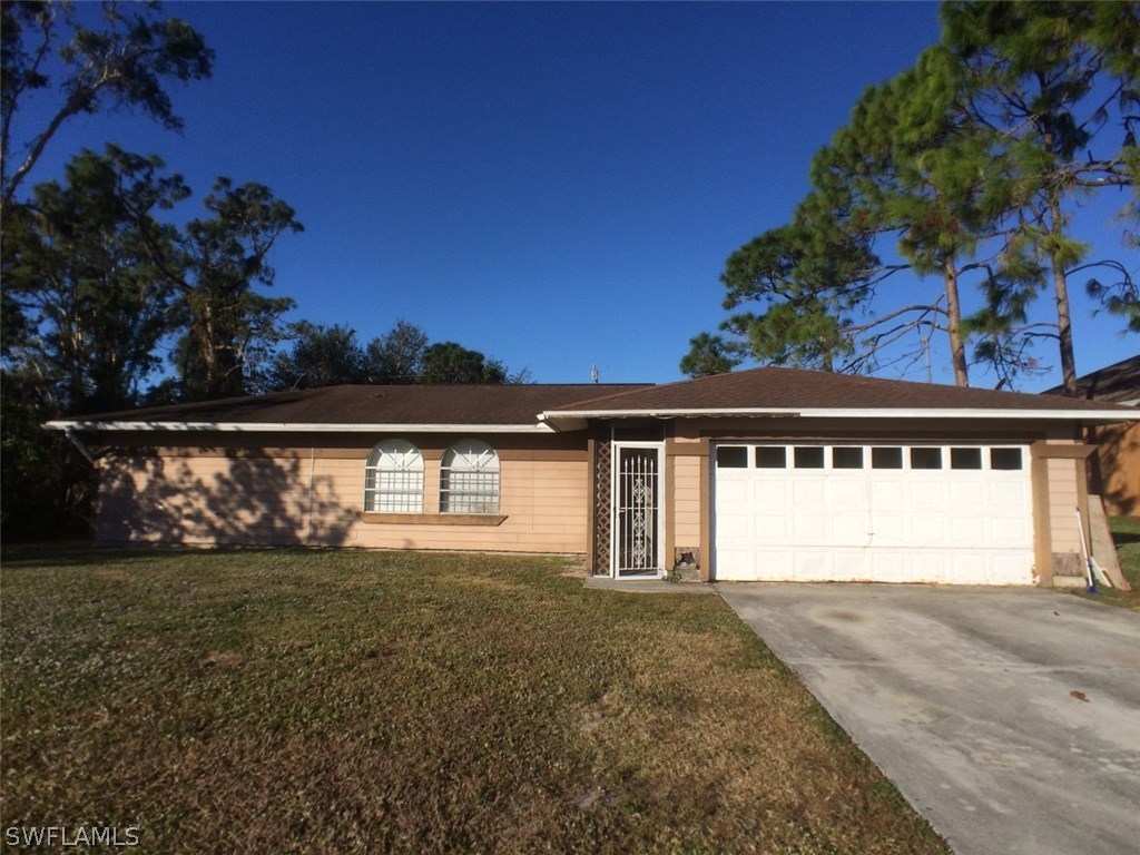 18250 Apple Road Fort Myers, FL 33967 - Photo 1 of 19 a front view of a house with a yard