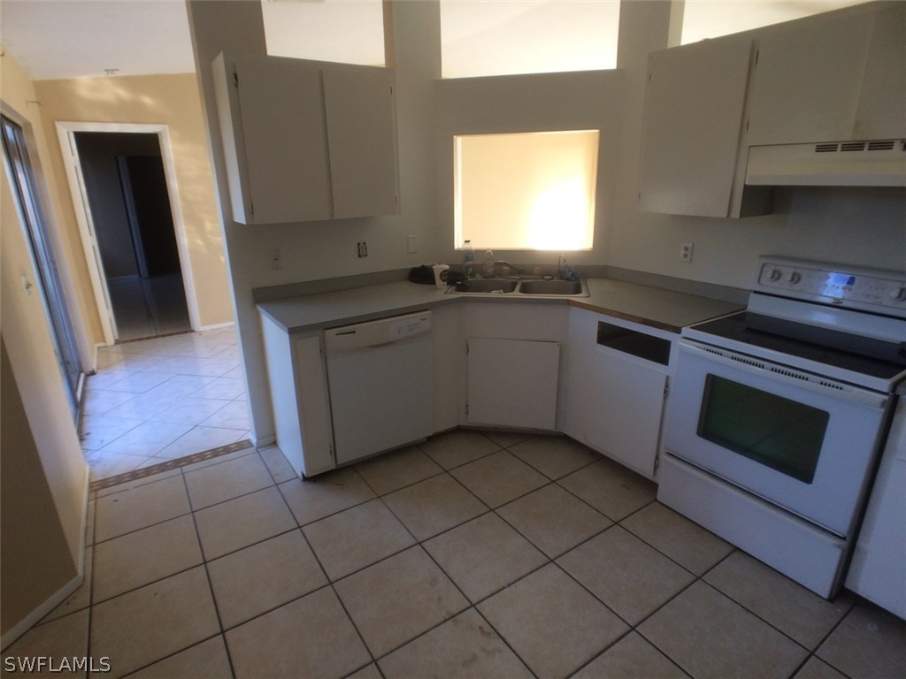 18250 Apple Road Fort Myers, FL 33967 - Photo 5 of 19 a kitchen with stainless steel appliances granite countertop a sink and a microwave
