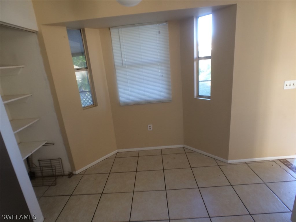 18250 Apple Road Fort Myers, FL 33967 - Photo 7 of 19 a view of an empty room with window and wooden floor