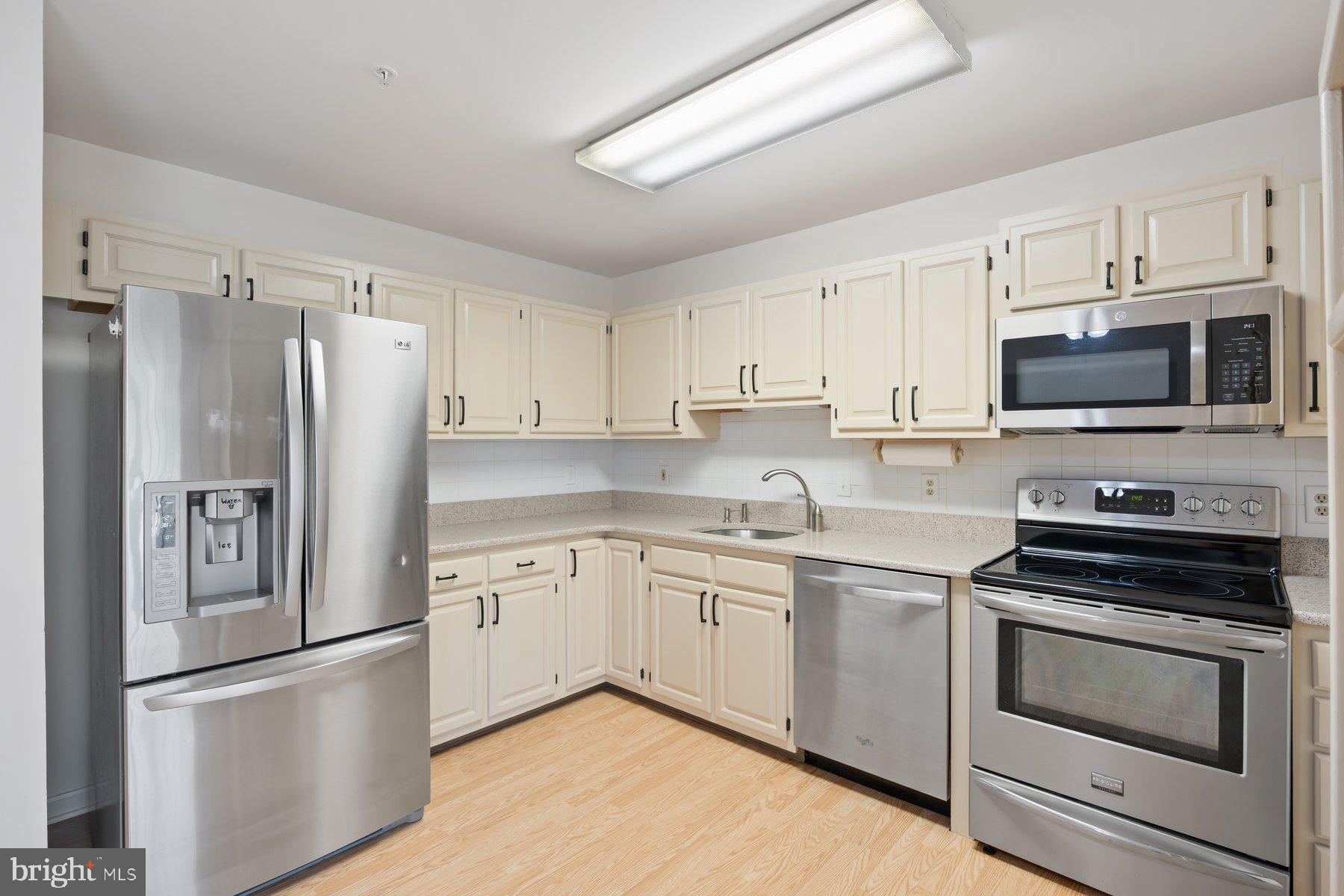 3901 Darleigh Road, Unit 1E Nottingham, MD 21236 - Photo 16 of 27 a kitchen with cabinets stainless steel appliances and a window