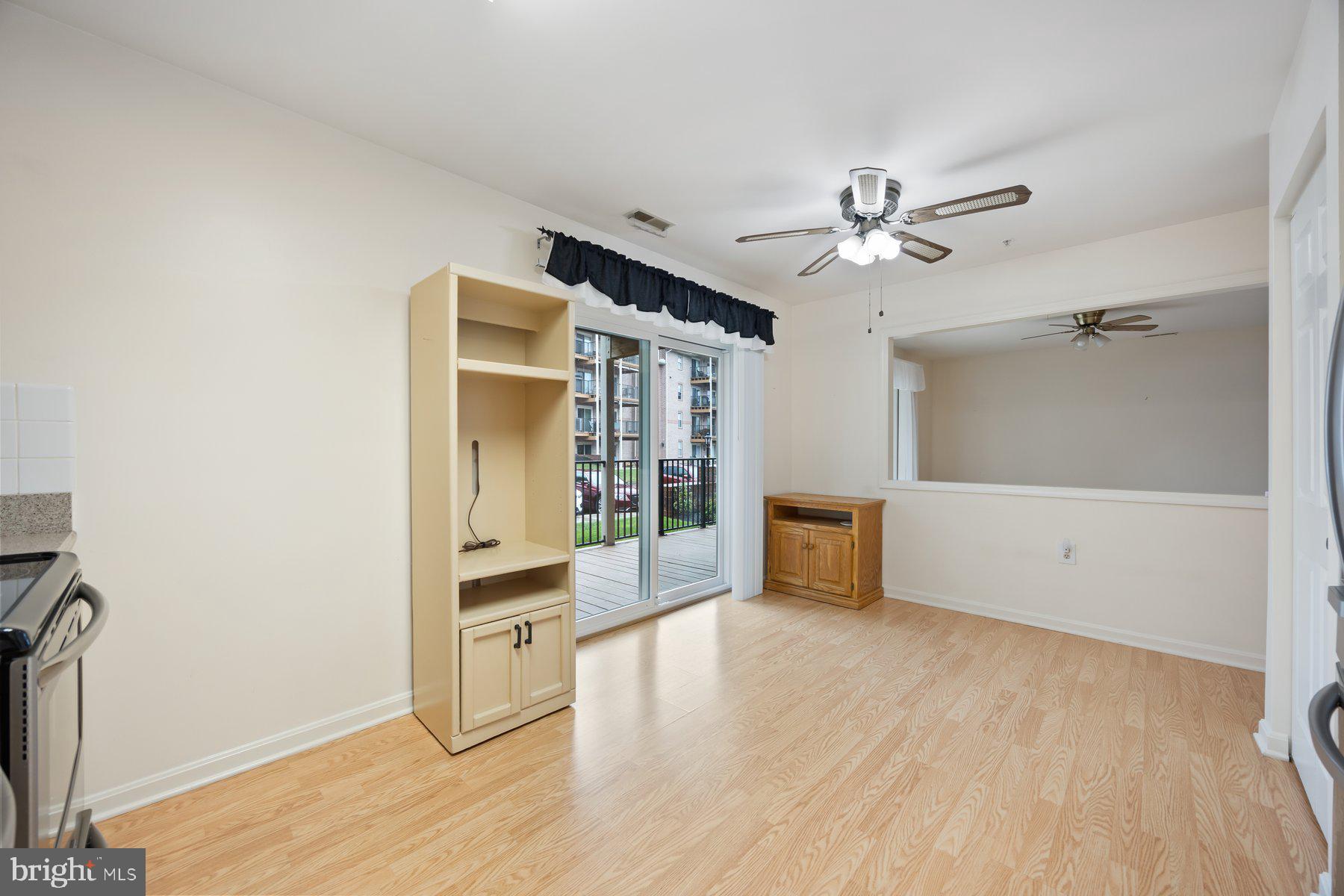 3901 Darleigh Road, Unit 1E Nottingham, MD 21236 - Photo 17 of 27 a view of a big room with wooden floor and a ceiling fan