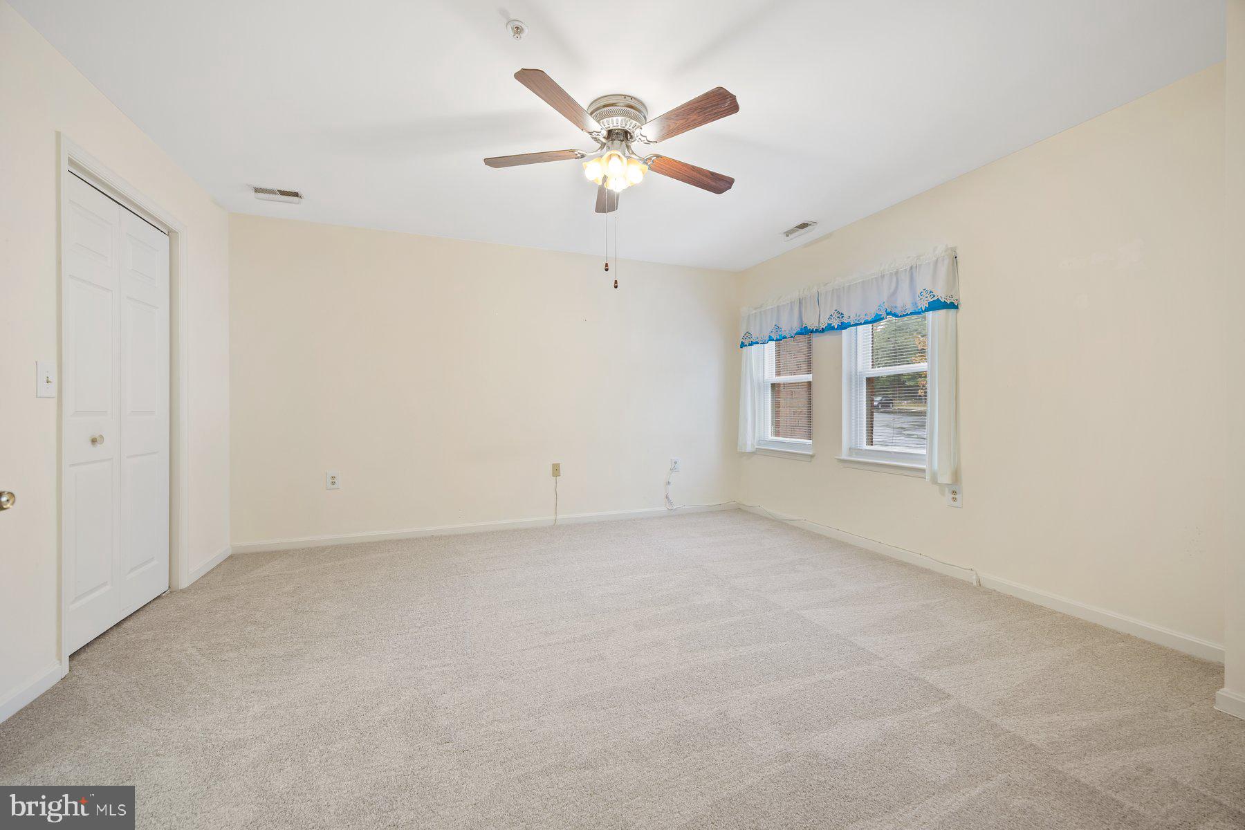 3901 Darleigh Road, Unit 1E Nottingham, MD 21236 - Photo 19 of 27 a view of an empty room with a ceiling fan and window