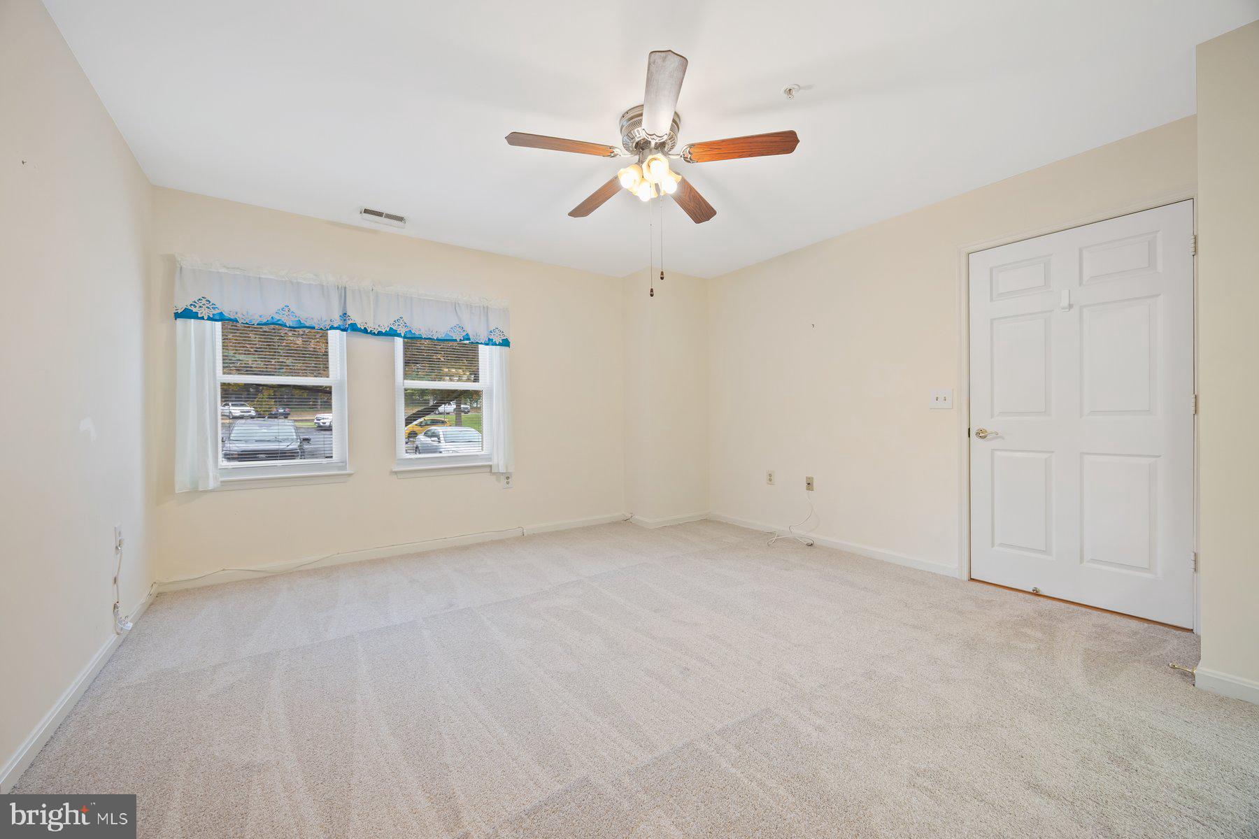 3901 Darleigh Road, Unit 1E Nottingham, MD 21236 - Photo 20 of 27 an empty room with windows and ceiling fan