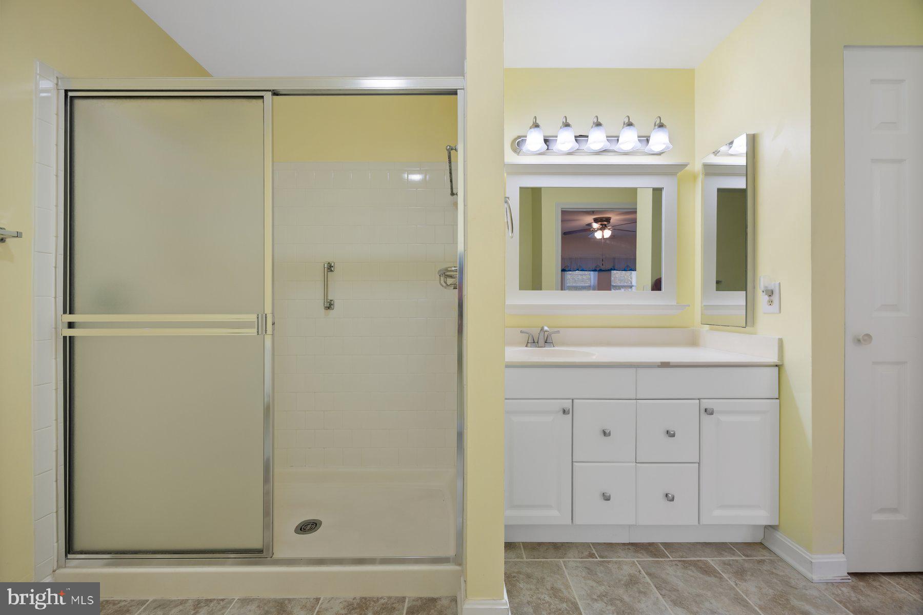 3901 Darleigh Road, Unit 1E Nottingham, MD 21236 - Photo 23 of 27 a bathroom with a sink a mirror a vanity and a shower