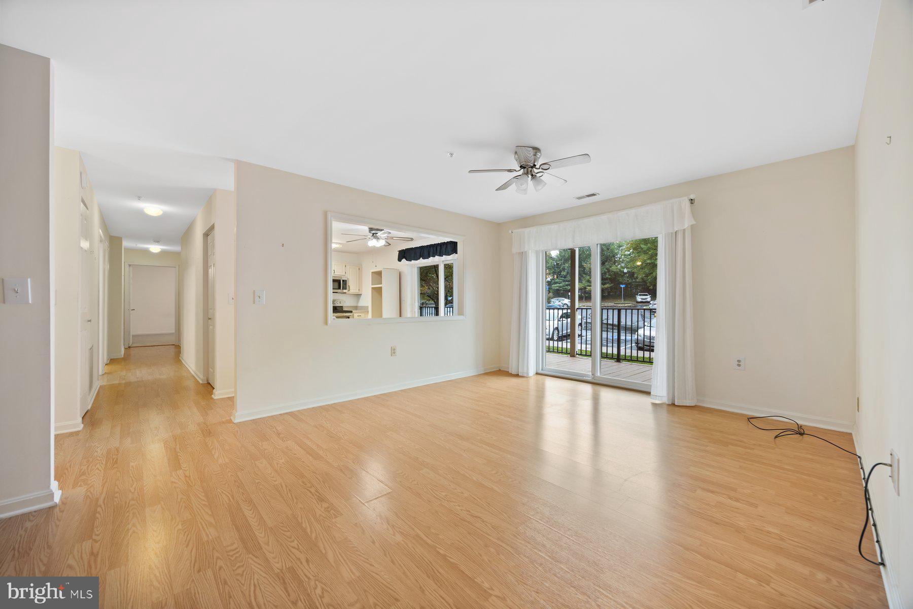 3901 Darleigh Road, Unit 1E Nottingham, MD 21236 - Photo 5 of 27 a view of an empty room with a window and wooden floor